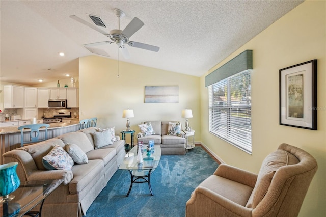 living room featuring a textured ceiling, ceiling fan, carpet floors, and lofted ceiling