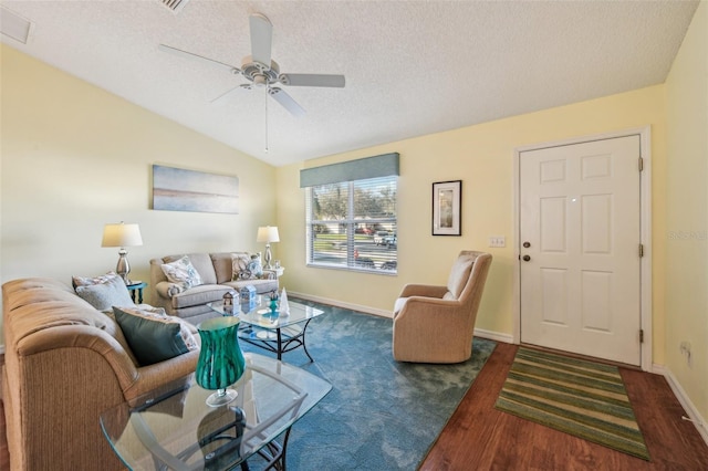 living room with ceiling fan, dark hardwood / wood-style floors, lofted ceiling, and a textured ceiling