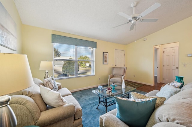 living room with a textured ceiling, ceiling fan, hardwood / wood-style floors, and vaulted ceiling