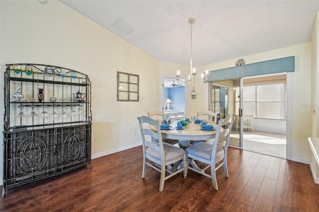 dining area featuring hardwood / wood-style floors, a chandelier, and lofted ceiling