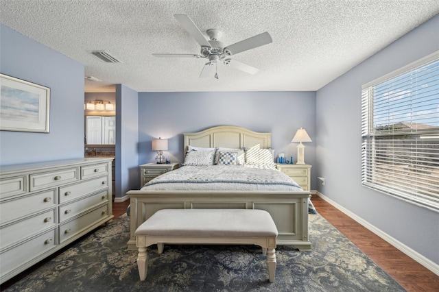 bedroom featuring ceiling fan, dark wood-type flooring, and a textured ceiling