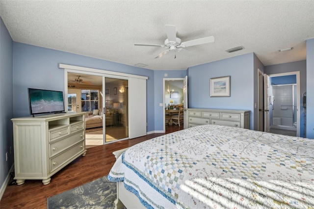 bedroom with a textured ceiling, ceiling fan, and dark wood-type flooring