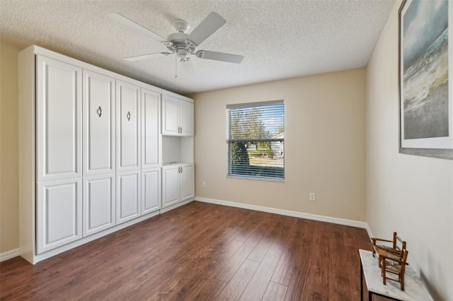 bedroom with ceiling fan, dark hardwood / wood-style floors, a textured ceiling, and a closet