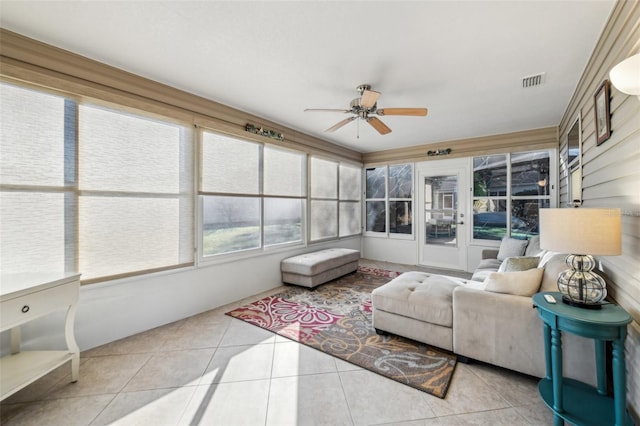 sunroom / solarium featuring ceiling fan