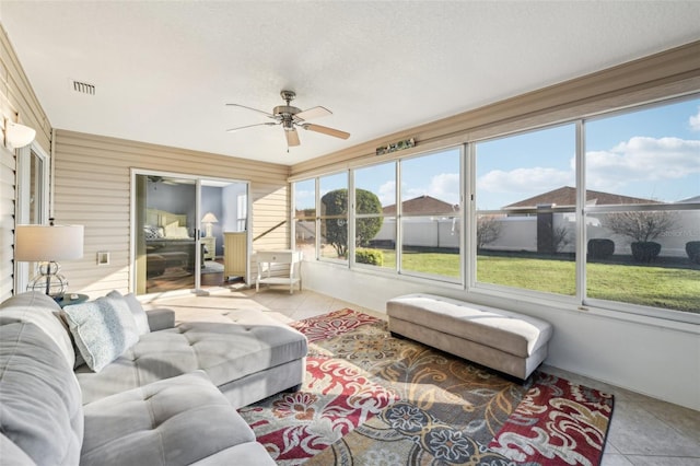 sunroom featuring plenty of natural light and ceiling fan