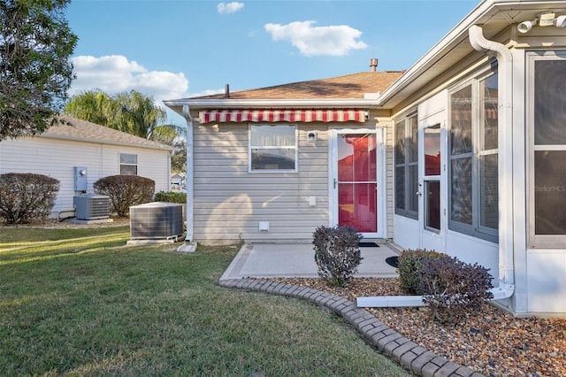 exterior space featuring a lawn and central AC