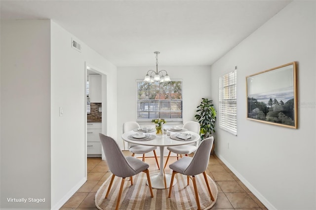 dining room featuring light tile patterned floors and a notable chandelier