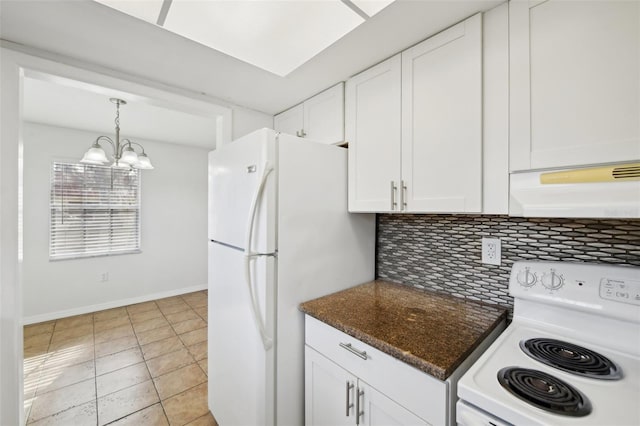 kitchen featuring a notable chandelier, backsplash, extractor fan, white appliances, and white cabinets