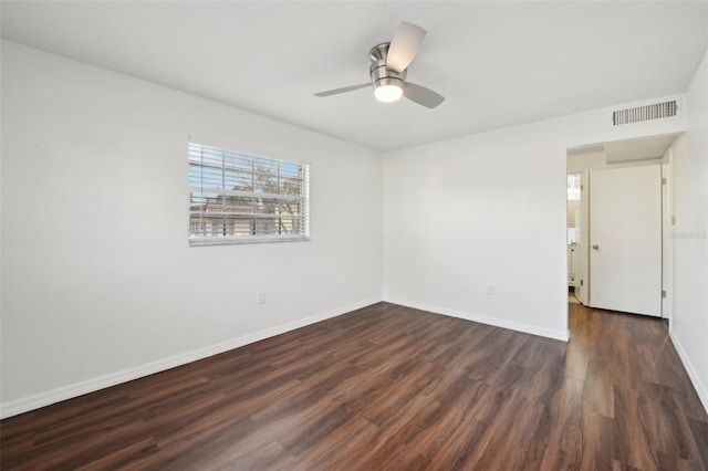 spare room featuring ceiling fan and dark wood-type flooring