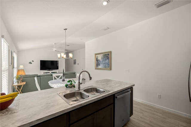 kitchen featuring dark brown cabinetry, sink, stainless steel dishwasher, pendant lighting, and lofted ceiling