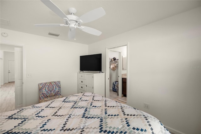 bedroom featuring a spacious closet, a closet, and ceiling fan