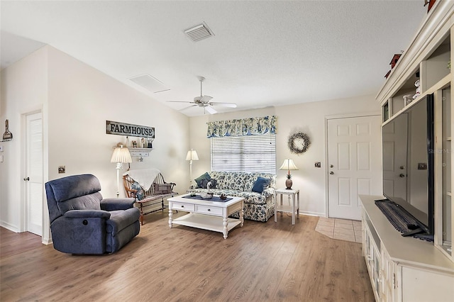 living room featuring hardwood / wood-style floors, a textured ceiling, ceiling fan, and lofted ceiling