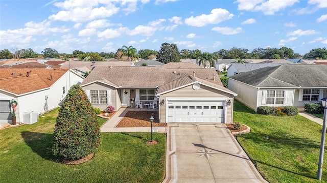 ranch-style home with covered porch, a garage, and a front lawn