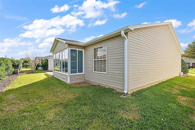 view of side of home featuring a lawn