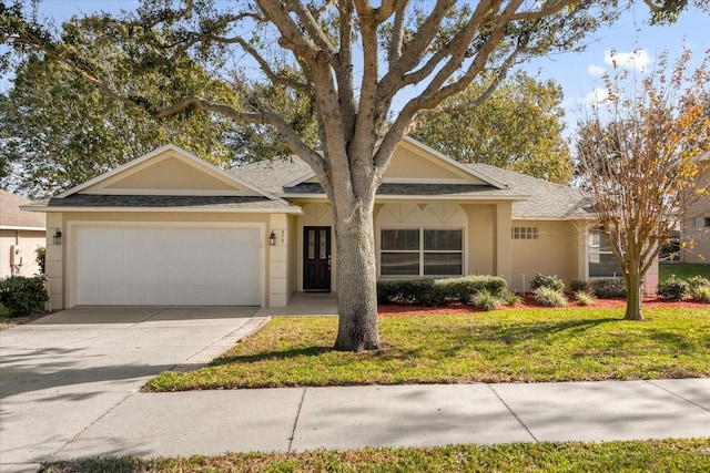 view of front of property with a front yard and a garage