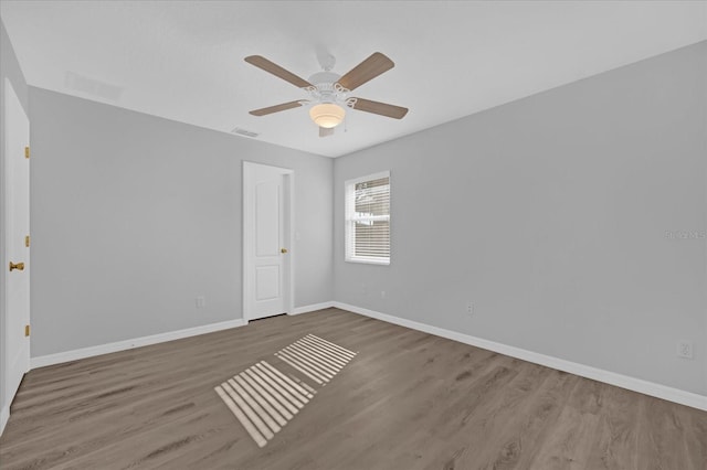 unfurnished room with hardwood / wood-style floors and ceiling fan