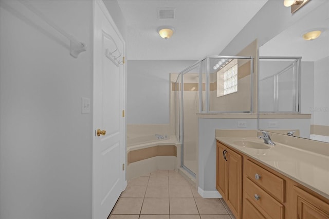 bathroom with tile patterned flooring, vanity, and separate shower and tub