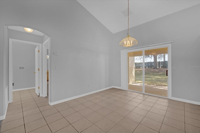 unfurnished room featuring an inviting chandelier, light tile patterned floors, and vaulted ceiling