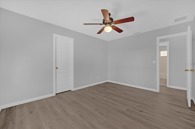 spare room featuring light hardwood / wood-style flooring and ceiling fan