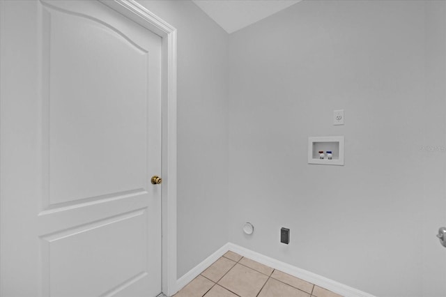 washroom featuring hookup for a washing machine and light tile patterned floors