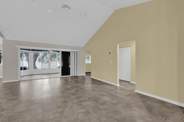 unfurnished living room featuring ceiling fan and high vaulted ceiling