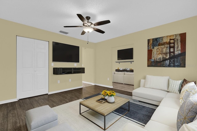 living room featuring dark hardwood / wood-style floors and ceiling fan