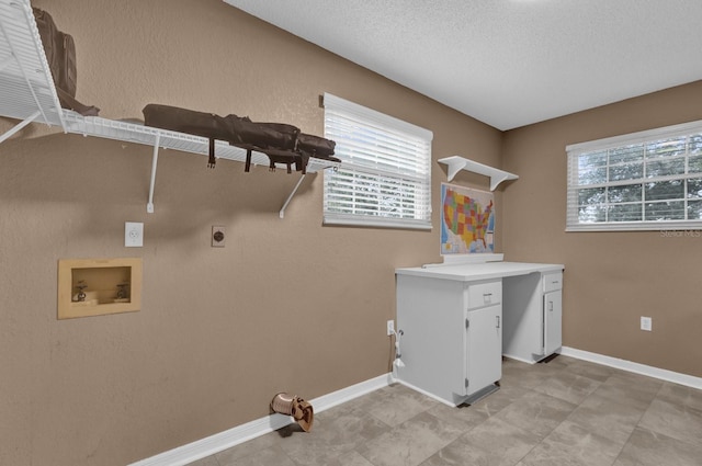 washroom featuring cabinets, washer hookup, hookup for an electric dryer, and a textured ceiling