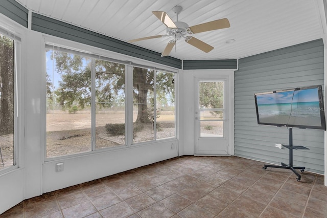 unfurnished sunroom featuring ceiling fan