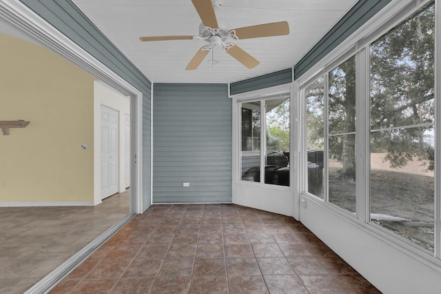 unfurnished sunroom featuring ceiling fan