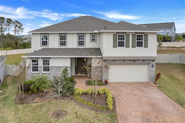 view of front of property featuring a front yard and a garage