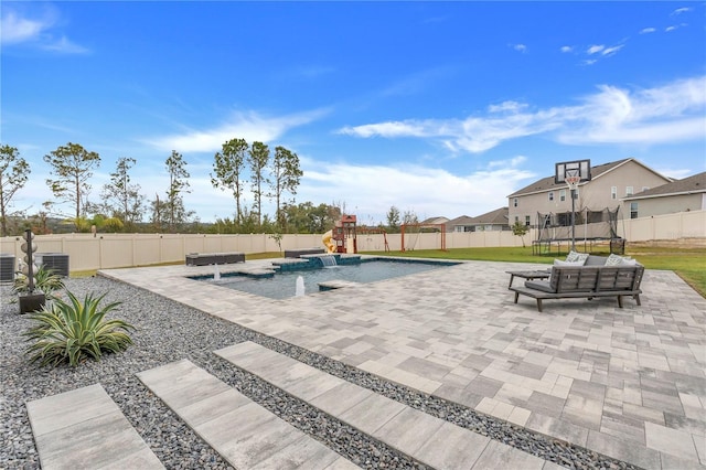 410 Cheeota Ct, Minneola, FL 34715 - view of swimming pool with a trampoline, a patio area, and a fenced backyard
