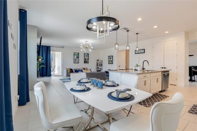 tiled dining area featuring a notable chandelier and sink