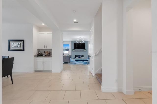 hall featuring light tile patterned floors