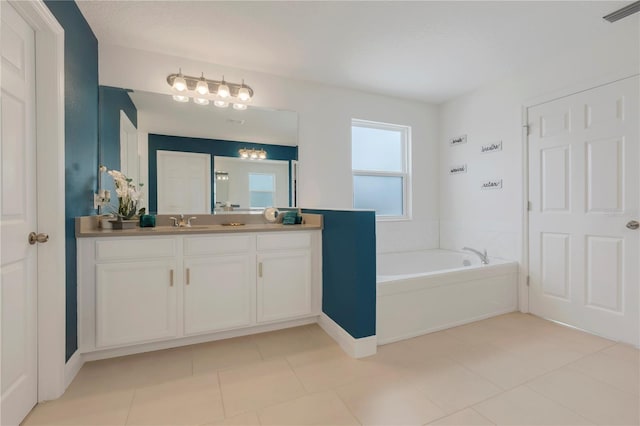 bathroom featuring a washtub, vanity, and tile patterned flooring