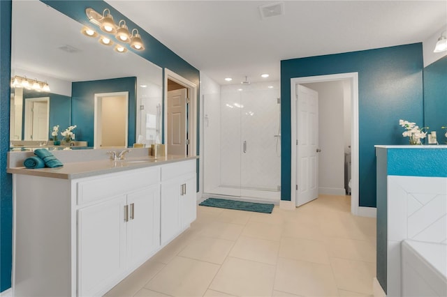 bathroom featuring tile patterned flooring, shower with separate bathtub, and vanity