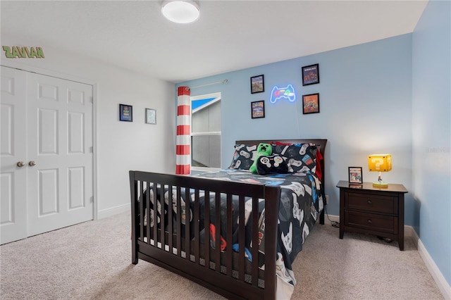 bedroom featuring light carpet and a closet