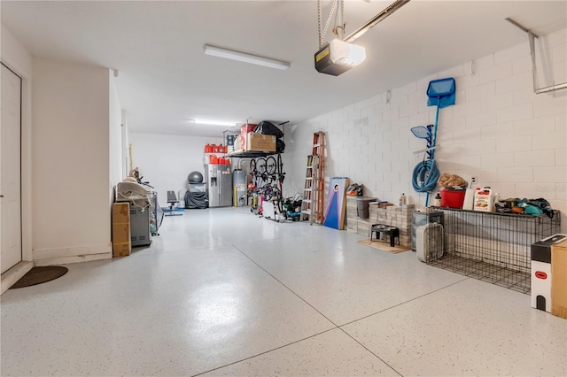 garage featuring water heater and a garage door opener