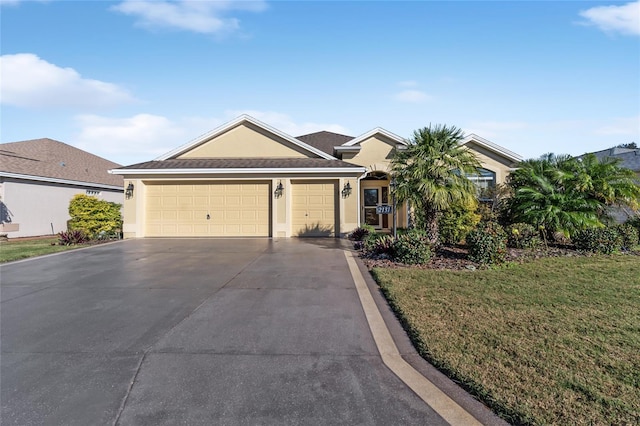 single story home featuring a garage and a front yard