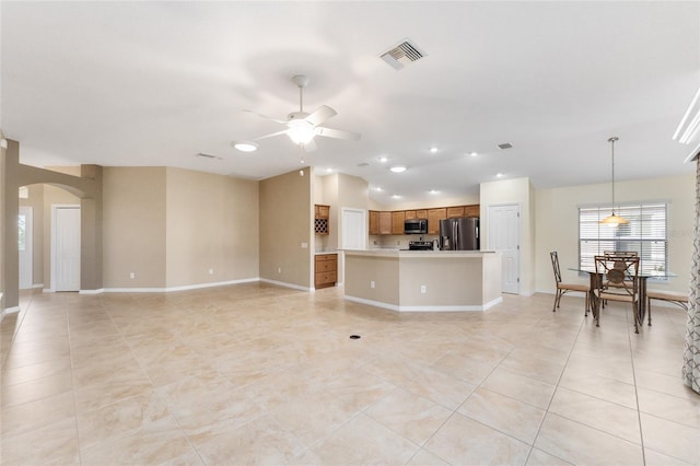 unfurnished living room with ceiling fan and light tile patterned floors