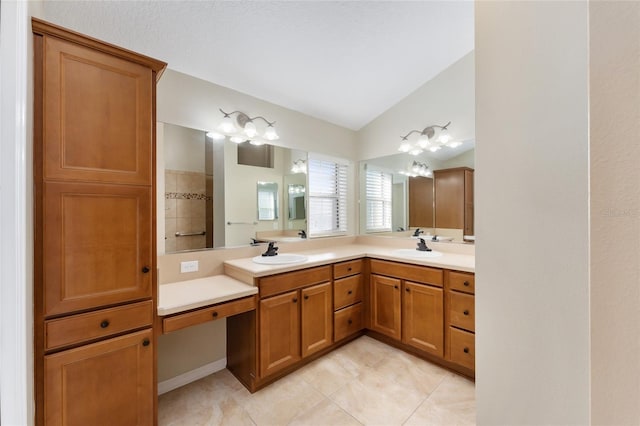 bathroom featuring vanity, tile patterned floors, and lofted ceiling