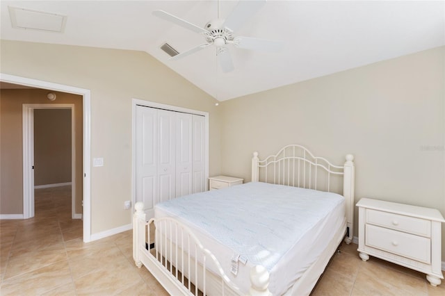 tiled bedroom with ceiling fan, a closet, and vaulted ceiling