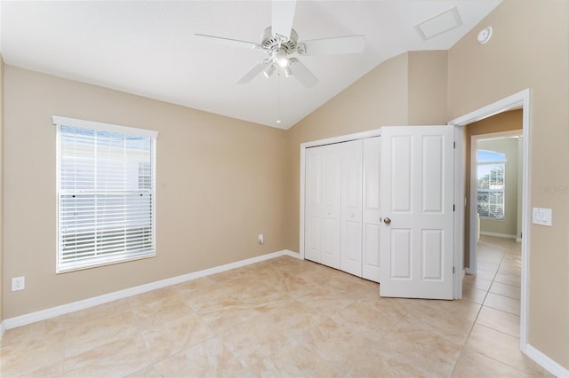 unfurnished bedroom with ceiling fan, a closet, light tile patterned floors, and lofted ceiling