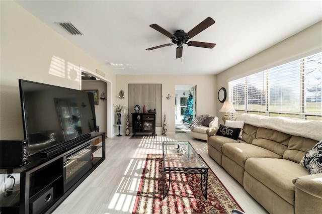 living room with ceiling fan and light hardwood / wood-style floors