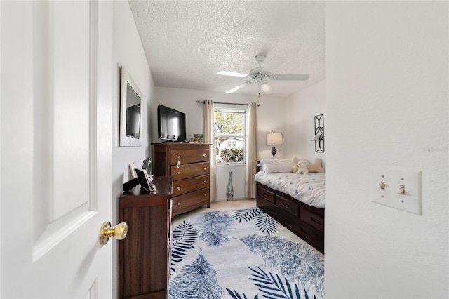 bedroom with a textured ceiling and ceiling fan