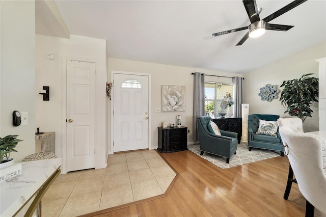 living room featuring ceiling fan and light hardwood / wood-style floors