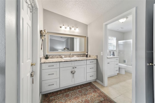 full bathroom featuring tile patterned flooring, a textured ceiling, toilet, shower / bath combination with glass door, and vanity