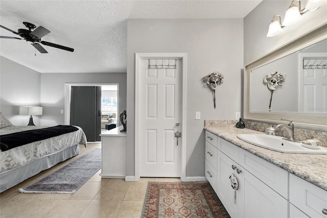 bathroom featuring tile patterned flooring, vanity, a textured ceiling, and ceiling fan