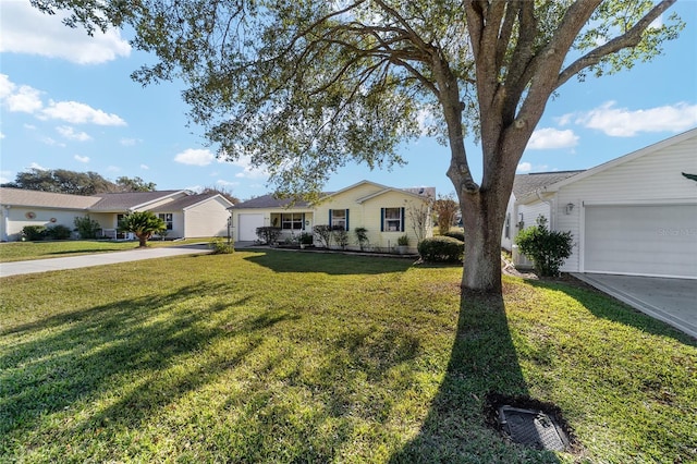 single story home featuring a garage and a front yard