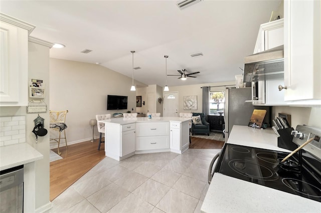 kitchen featuring stainless steel appliances, ceiling fan, light tile patterned floors, decorative light fixtures, and white cabinetry