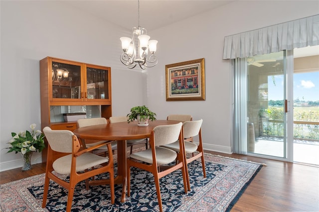 dining room with wood-type flooring and a chandelier